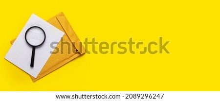 magnifying glass, blank white sheet and envelope on a yellow background. Banner.