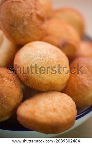 Traditional Kazakh Asian baursak dish prepared with dough on a pan with oil, selective focus, vertical