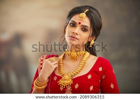 Beautiful Indian woman in traditional dress and jewelry. Royalty-Free Stock Photo #2089306315