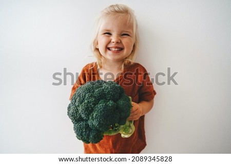 Child with broccoli vegetable healthy food vegan cooking eating sustainable lifestyle organic veggies harvest plant based diet nutrition funny kid girl happy smiling toddler Royalty-Free Stock Photo #2089345828