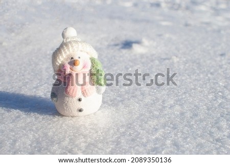 beautiful snowman on white snow in the sun