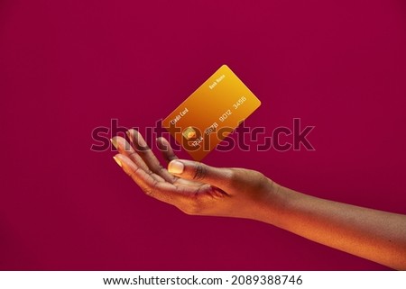 African american female hand and levitating template Bank credit card with online service on pink background Royalty-Free Stock Photo #2089388746