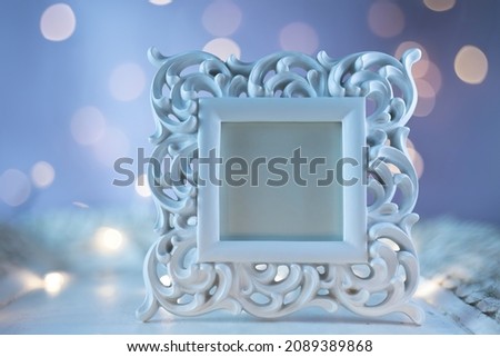 White Vintage Baroque Picture Photo Frame on the Blurred Lights Background