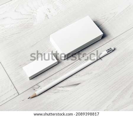 Photo of blank business cards, pencil and eraser. Template for branding identity.