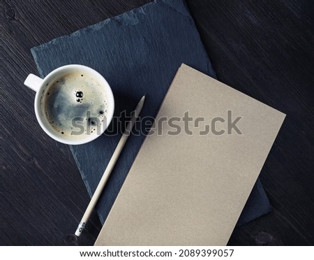 Blank kraft sketchbook, pencil and coffee cup. Stationery template.