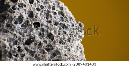 Meteorite rock detail, with light brown background
