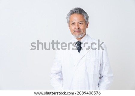 Asian senior doctor in a white coat Royalty-Free Stock Photo #2089408576