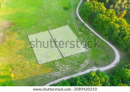 Land Plot for Housing on green field - aerial drone shot. Topographical Marking of two plots of Land for Private Residence House Construction. Land Plot plan Marking with white Overlay. Royalty-Free Stock Photo #2089420210