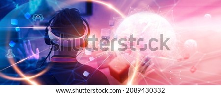 Metaverse Technology concepts. Teenager play VR virtual reality goggle and experiences of metaverse virtual world. Visualization and simulation, Gamer, 3D, AR, VR, Innovation of futuristic. Royalty-Free Stock Photo #2089430332