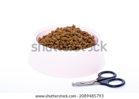 scissors for animal nail isolated and pink bowl on a white background.