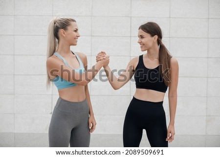 Two women doing fitness outdoor Royalty-Free Stock Photo #2089509691
