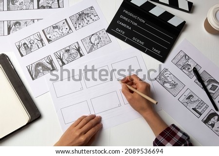 The artist draws a storyboard for the film. The director creates the storytelling by sketching footage of the script on paper. Royalty-Free Stock Photo #2089536694