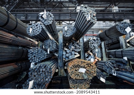 Rolled metal warehouse. Many packs of metal bars on the shelves Royalty-Free Stock Photo #2089543411