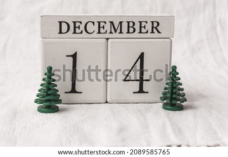 Save the date. December 14th. Day 14 of month, date calendar  and small Christmas trees on white background.  White block calendar present date 14 and month December, Advent, special occasions, websit