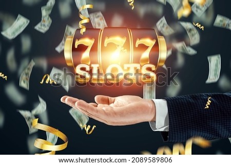 Slots creative background, Lucky seven 777 on Slot machine over hand, dark golden style. Casino concept, luck, gambling, jackpot, banner, template Royalty-Free Stock Photo #2089589806
