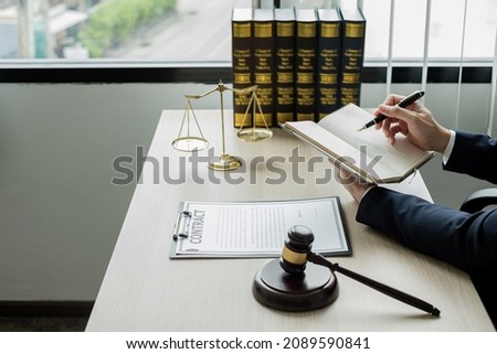 Professional man lawyers work at a law office There are scales, Scales of justice, judges gavel, and litigation documents. Concepts of law and justice.