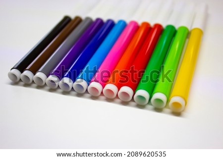 
Image of multi-colored markers on a white background.