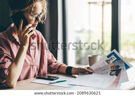  Manager looking at many different cv resume and choosing perfect person.  Royalty-Free Stock Photo #2089630621