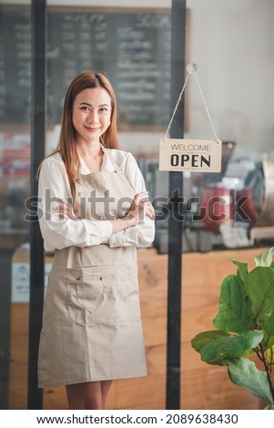 The owner of a small shop turned the sign to open, ready to serve.