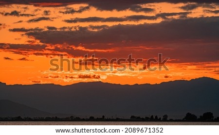 Beautiful dark orange sky evening beauty and Clouds at sunset , dawn, the rays of the sun break through the clouds. Natural