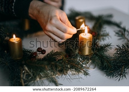 Celebrating Christmas time with homemade advent wreath with candles. Royalty-Free Stock Photo #2089672264