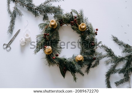 Celebrating Christmas time with homemade advent wreath with candles. Royalty-Free Stock Photo #2089672270