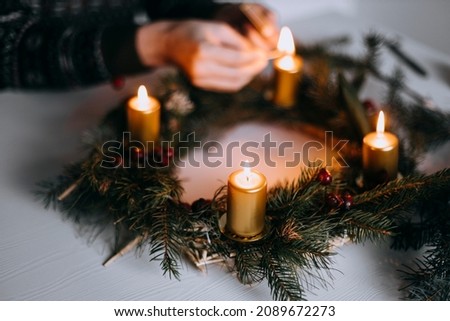 Celebrating Christmas time with homemade advent wreath with candles. Royalty-Free Stock Photo #2089672273
