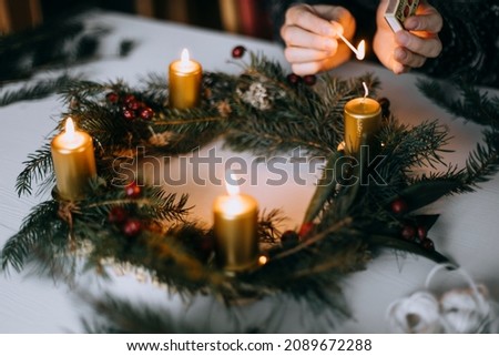 Celebrating Christmas time with homemade advent wreath with candles. Royalty-Free Stock Photo #2089672288