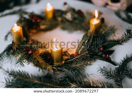 Celebrating Christmas time with homemade advent wreath with candles. Royalty-Free Stock Photo #2089672297