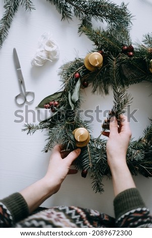 Celebrating Christmas time with homemade advent wreath with candles. Royalty-Free Stock Photo #2089672300