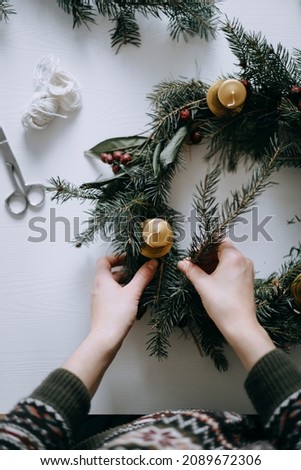 Celebrating Christmas time with homemade advent wreath with candles. Royalty-Free Stock Photo #2089672306