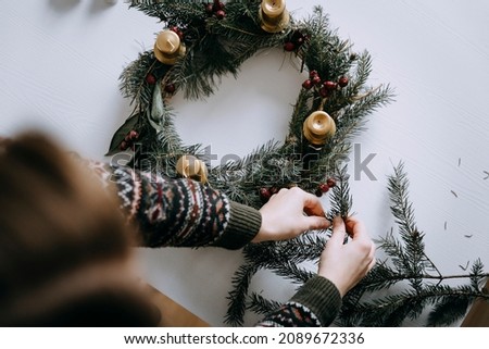 Celebrating Christmas time with homemade advent wreath with candles. Royalty-Free Stock Photo #2089672336