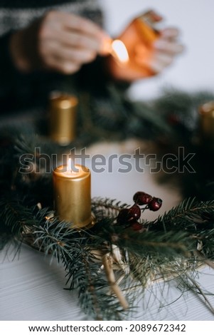 Celebrating Christmas time with homemade advent wreath with candles. Royalty-Free Stock Photo #2089672342