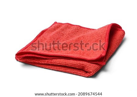 This is close up view of red micro fiber kitchen napkin on a white background. This is isolated view of red towel. Royalty-Free Stock Photo #2089674544