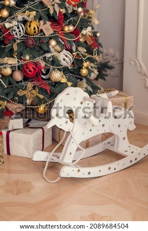 Children's horse with stars stands under the Christmas tree