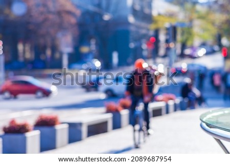 Cyclist rides in the city at the crossroads, city and many cars, transport on the street, blurred background
