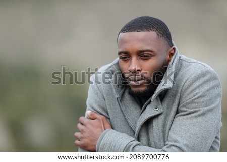Stressed man with black skin getting cold with a jacket outdoors in winter Royalty-Free Stock Photo #2089700776