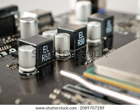 A voltage regulator module, VRM, processor power module, PPM,  is a buck converter that provides microprocessor and chipset the appropriate supply voltage, converting +3.3 V, +5 V or +12 V to lower  Royalty-Free Stock Photo #2089707289