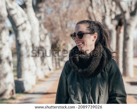 Profile of a young girl smiling while taking a walk