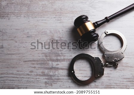 judge's hammer and handcuffs on the table Royalty-Free Stock Photo #2089755151