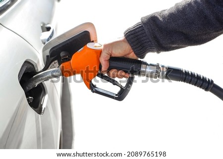 Man holding gas hose, gasoline pump nozzle isolated on white background. Fuel nozzle with the hose, Pumping gasoline fuel in car at a petrol station, Copy Space.  Royalty-Free Stock Photo #2089765198