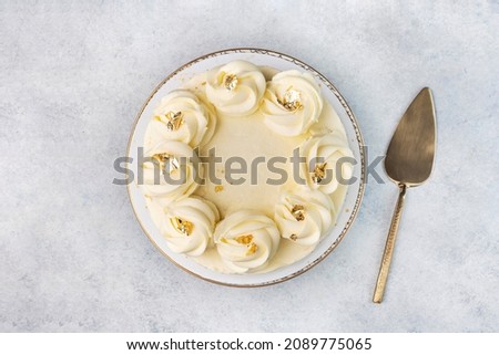 Beautiful tasty white cake with white cream; on cake stand Royalty-Free Stock Photo #2089775065
