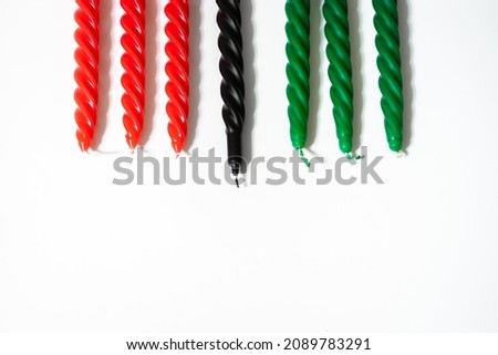 Happy Kwanzaa concept. African-American holiday. Seven candles - red, black and green. African heritage symbol on a white background.