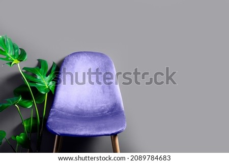 Modern Purple Very Peri Velour Chair on wooden legs, grey background Royalty-Free Stock Photo #2089784683