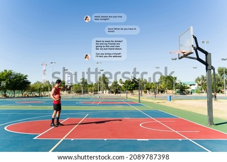 Fitness young man using the metaverse and playing basketball while texting with his augmented reality smartwatch 