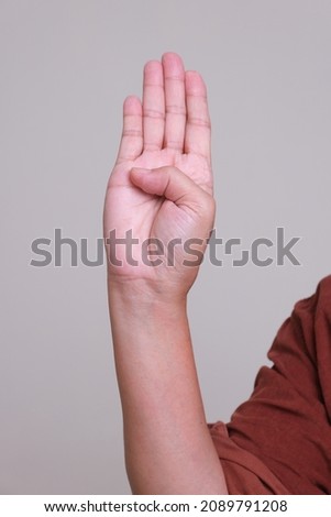 International signal for help created by the Canadian Women’s Foundation: 1. Palm to others and tuck thumb. Royalty-Free Stock Photo #2089791208