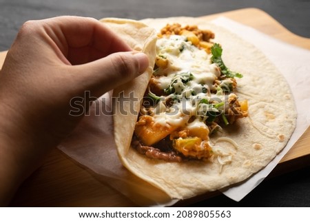Picadillo burrito with beans and cheese. Traditional Mexican food