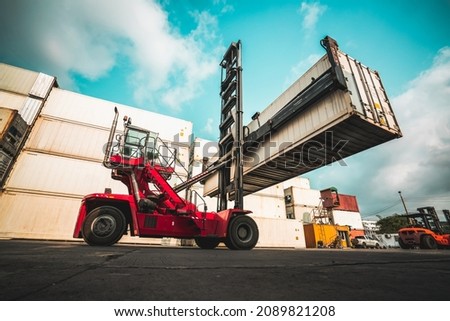 Cargo container for overseas shipping in shipyard with heavy machine . Logistics supply chain management and international goods export concept . Royalty-Free Stock Photo #2089821208