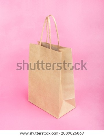 paper shopping bag on beauty pink background.