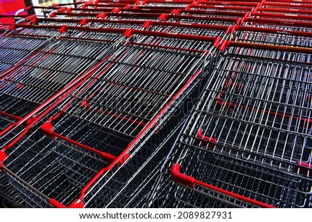 The chrome metal shopping carts were placed for supermarket shoppers.